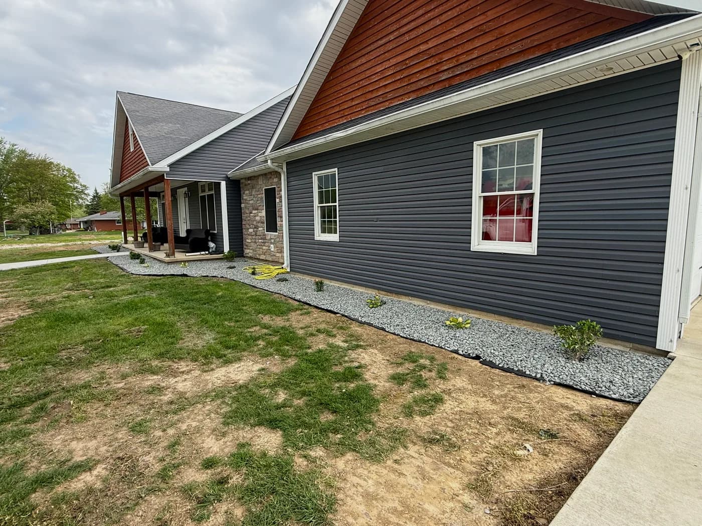 Landscaped beds framing a modern gray home